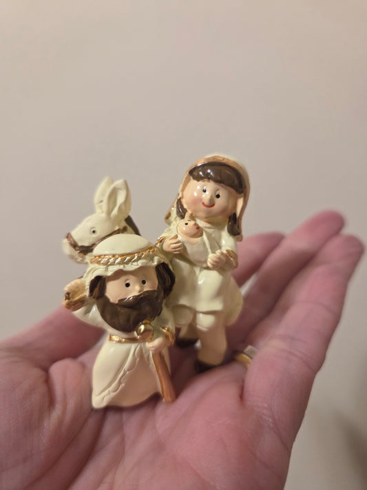 Sacred family with donkey - Nativity scene.